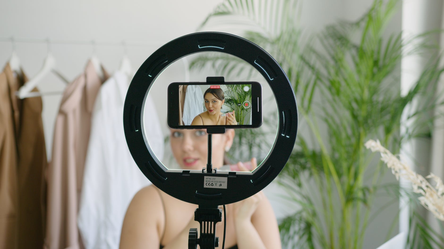 a woman video recording herself using a cellphone camera
