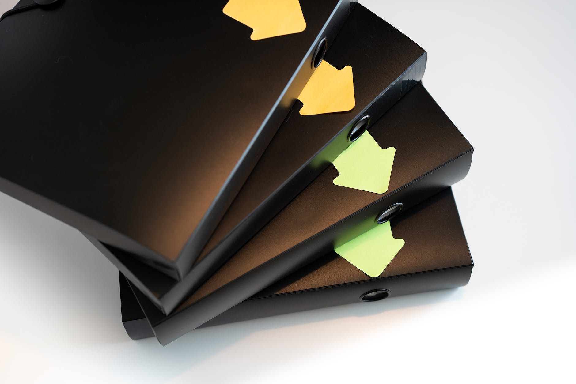 black folders with documents and contracts isolated on a white background segregated with stickers in the shape of arrows workflow direction office work and household bills