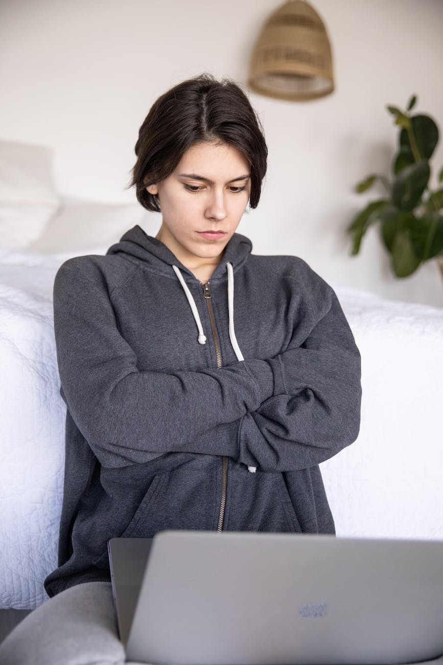 focused young woman using laptop at home