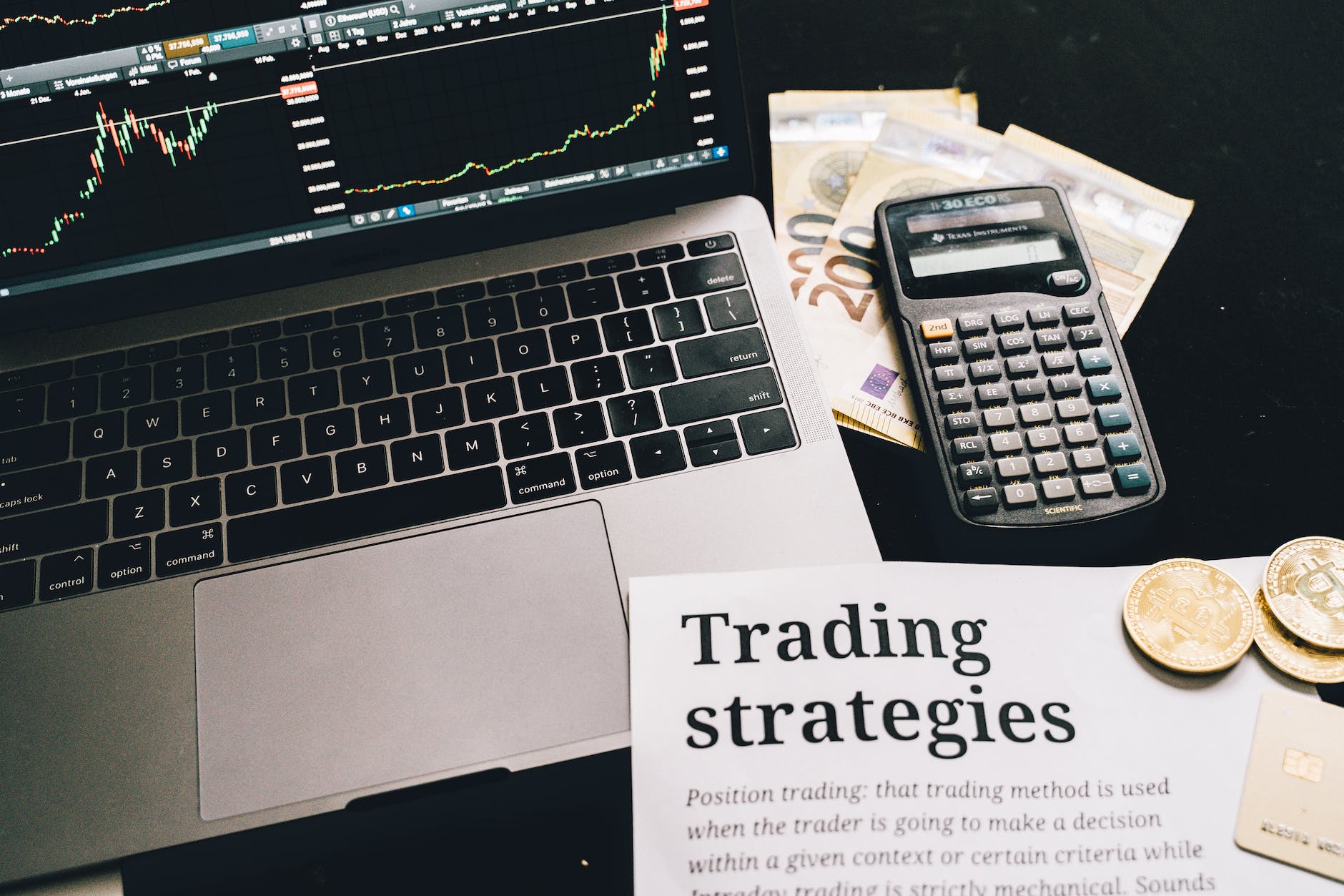 research paper on trading strategies beside calculator and laptop