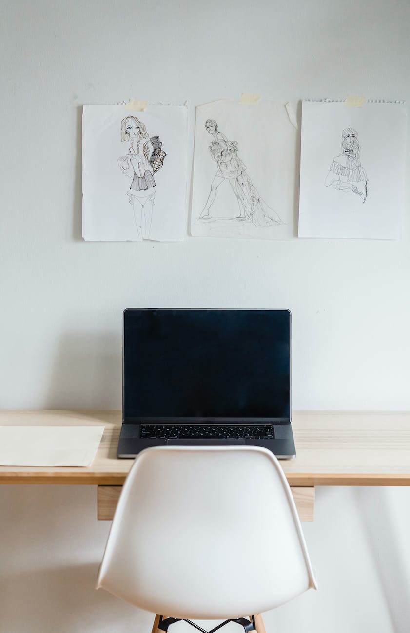 laptop at wall with sketches in atelier
